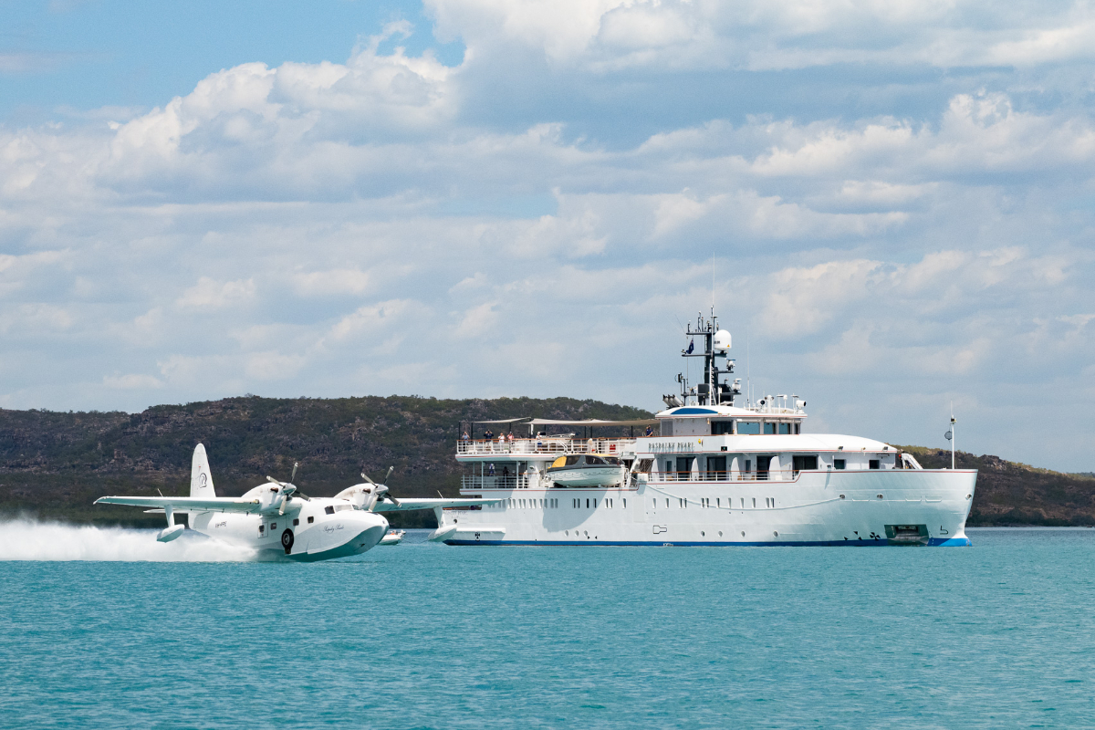 A Paspaley Grumman Mallard flying boat passing Paspaley Pearl in the Kimberley