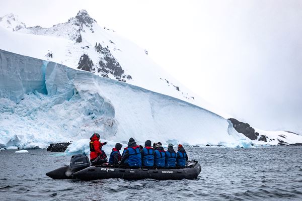 Zodiac exploring beneath Antarctic glaciers