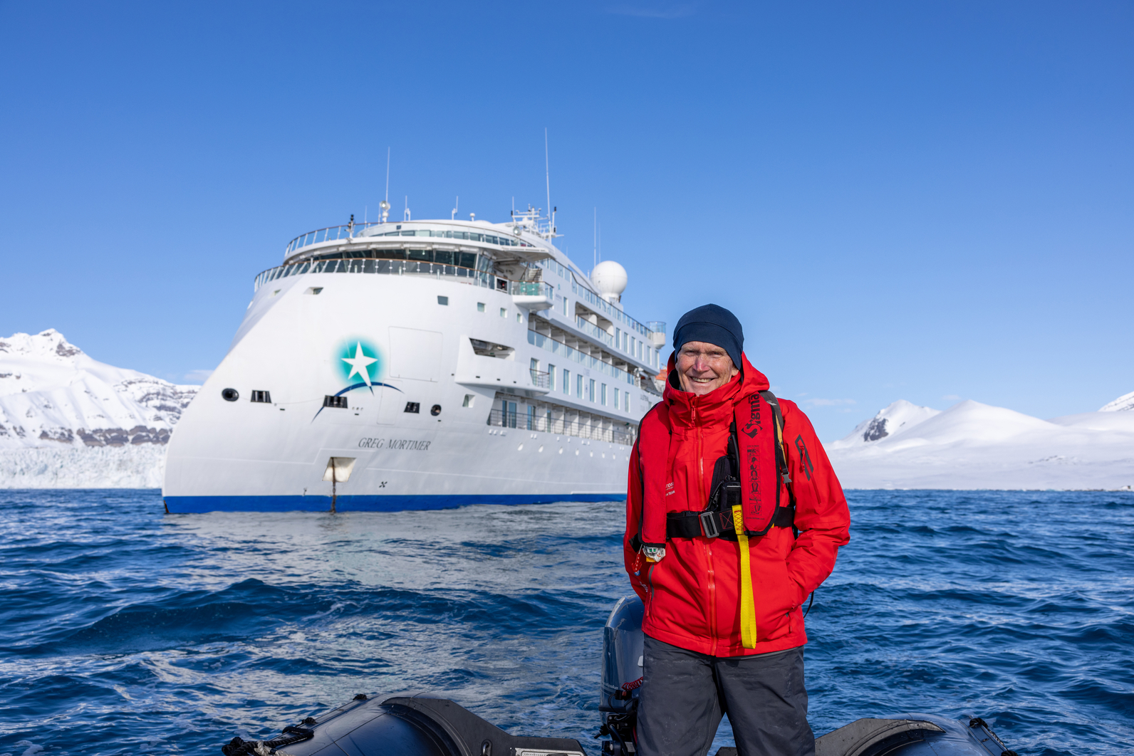 AE Expeditions founder Greg Mortimer in front of the expedition ship Greg Mortimer
